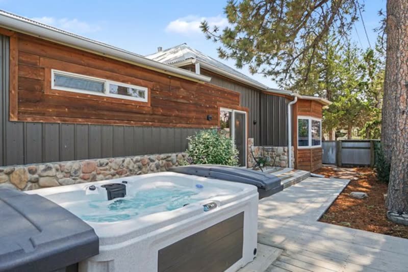 The hot tub in the enclosed back yard of the main house